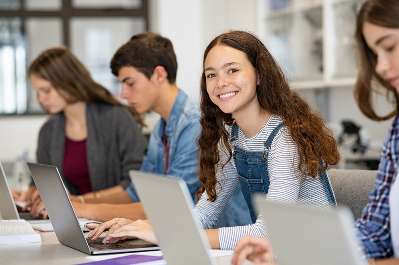 Teenager smiling with their Invisalign aligner